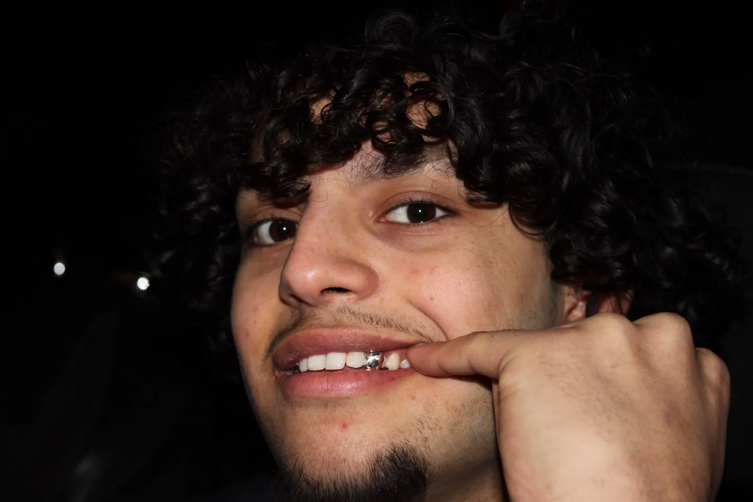 A Matrix client at night with a custom gold grillz tooth