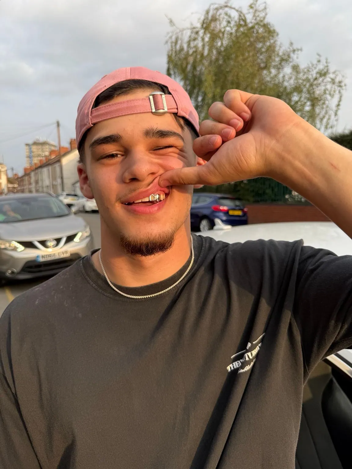 A Matrix client in a pink cap showing his grillz