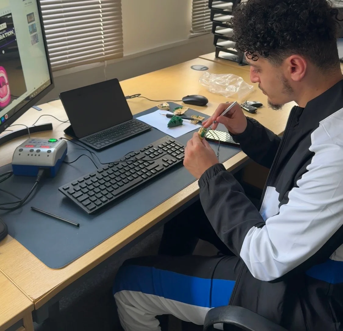 The Matrix founder at his desk, working on a small model with a fine tool